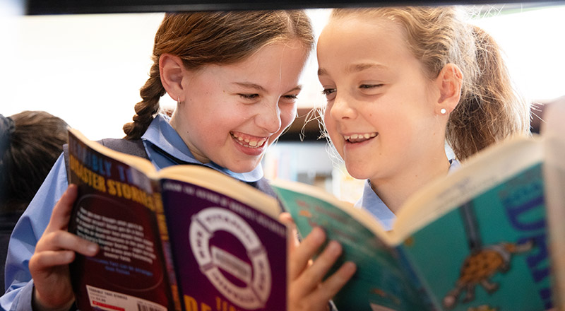 St Michael's Primary School Blacktown South students having fun reading in the school library