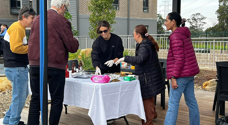 Parents volunteering at a school bbq at St Michael's Primary School Blacktown South