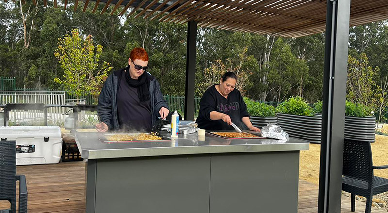 Parents volunteering at a school bbq at St Michael's Primary School Blacktown South
