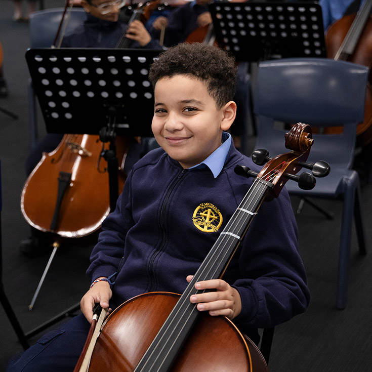 Student with his cello at St Michael's Primary School Blacktown South
