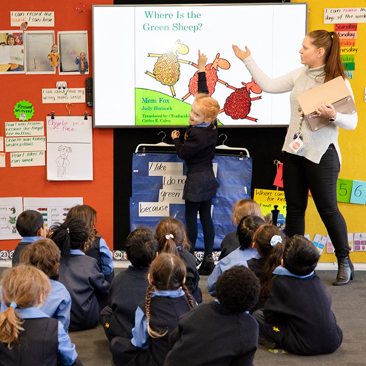 St Michael's Primary School Blacktown South teacher and student having fun at the whiteboard