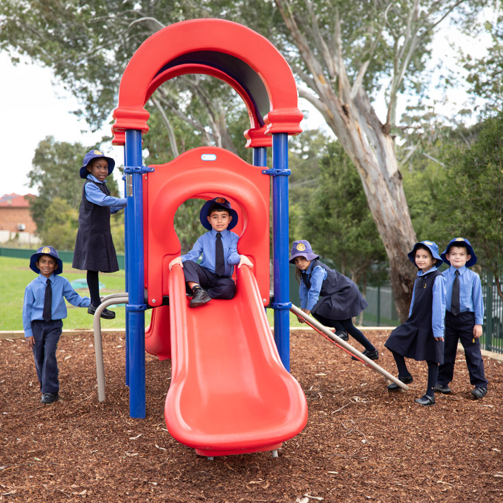 Students playing on the play equipment at St Michael's Primary School Blacktown South