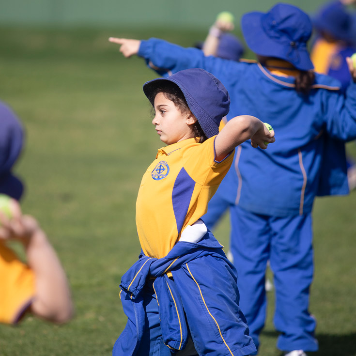 Student throwing a ball during sports class at St Michael's Primary School Blacktown South